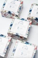 Several boxes of CAE reusable bamboo nursing pads with floral packaging