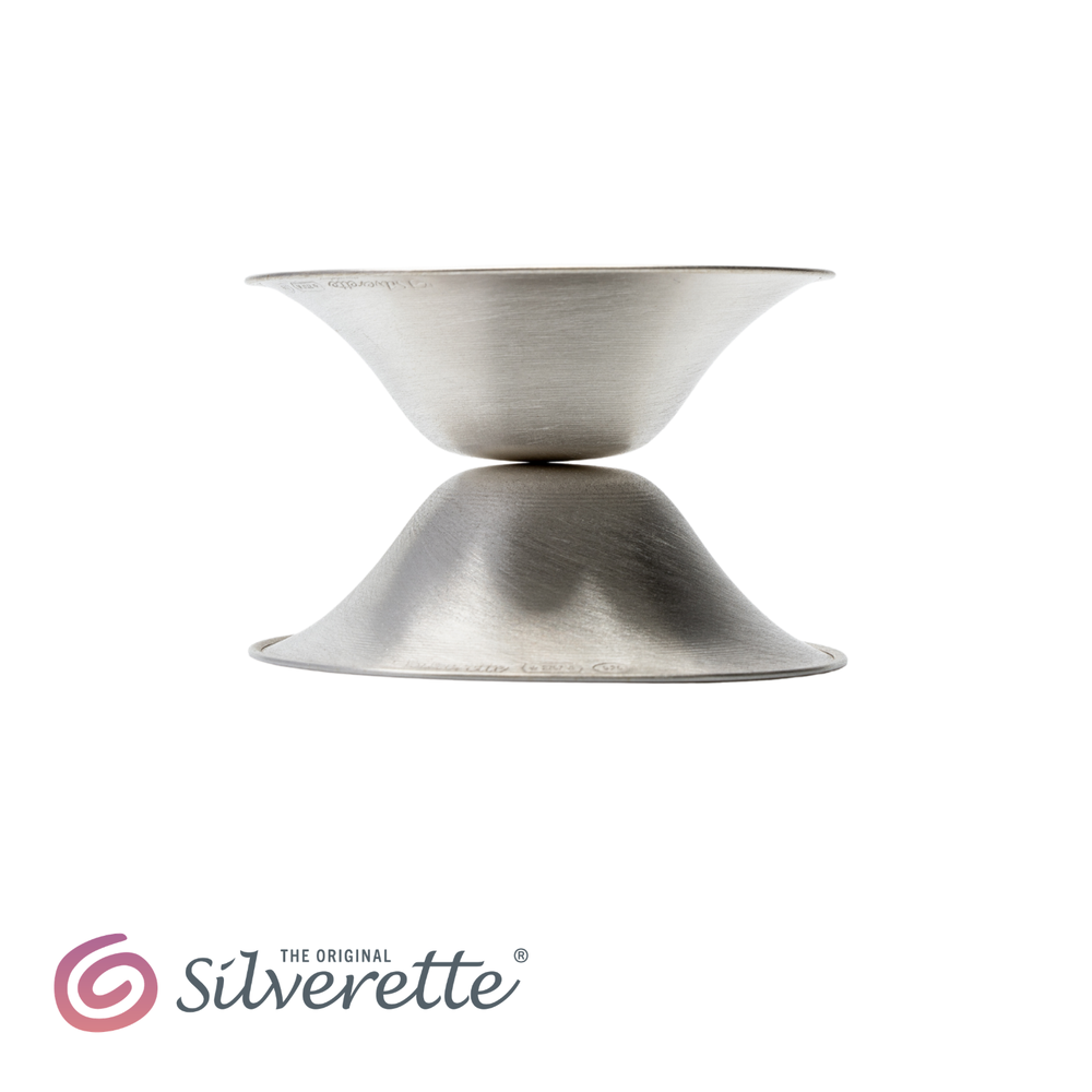 Silverette® Nursing Cups in silver, designed for breastfeeding comfort, shown on a white background with four cups arranged neatly.